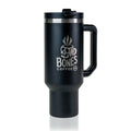 The front of a 40 ounce tumbler that is black colored. It has the Bones Coffee Company skull logo that has a skull that looks like a mug with steam coming out of the top of it. This tumbler has a handle and closable lid on it.