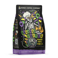 The front of a 12 ounce bag of Bones Coffee Company Bananas Foster coffee. Its flavor is banana, rum, and vanilla, and it has a skeleton wearing a chef’s hat and mardi gras glasses with balloons with the New Orleans emblem on the art.