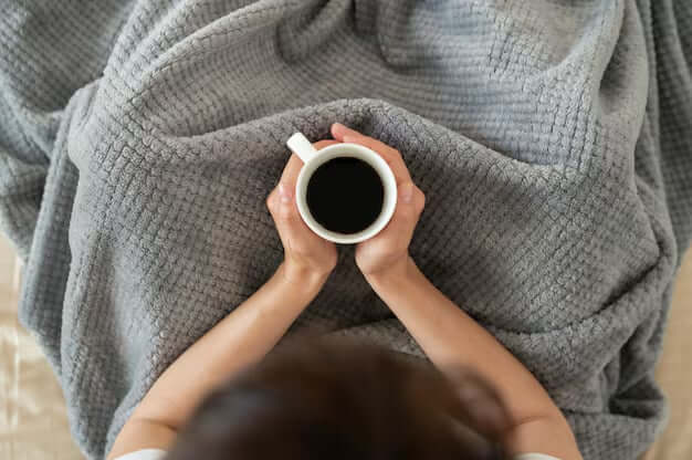 close up hands holding coffee cup