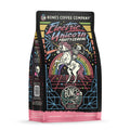 The front of a 12 ounce bag of Bones Coffee Company Electric Unicorn coffee. Its flavor is fruity cereal, and it has a skeleton riding a unicorn in front of a rainbow on the art.