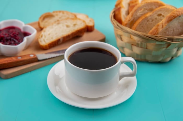 Black coffee with bread and berry jam.