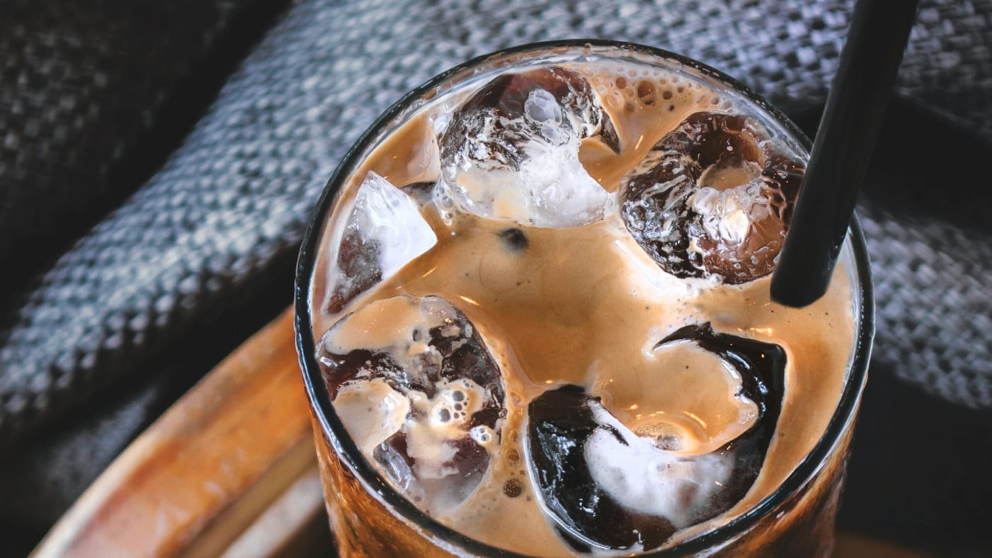 glass of iced latte with straw