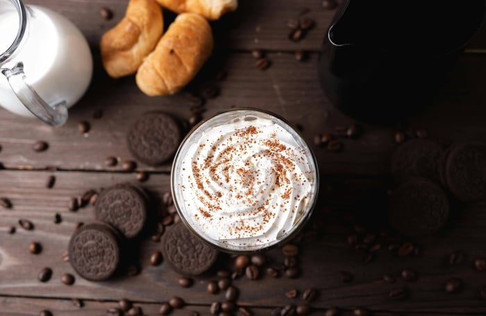 coffee topped with heavy whipping cream and cocoa powder
