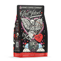 The front of a 12 ounce flavored coffee bag named Red Velvet. It showcases a skeleton with wings and aiming a bow and arrow on its art.