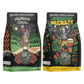 The front of two twelve ounce bags of Bones Coffee Company flavored coffee. The bag on the left is Highland Grog, and the bag on the right is Jamaican Me Crazy. Highland Grog is butterscotch and caramel flavor, Jamaican Me Crazy is vanilla, caramel, and coffee liqueur flavor.