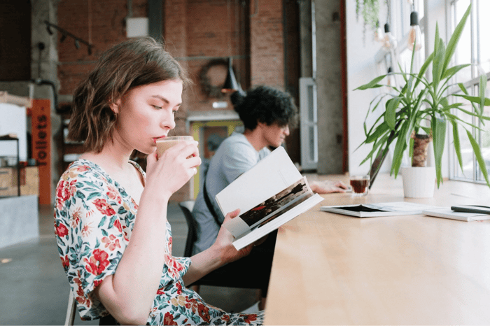 woman in floral dress drinking coffee