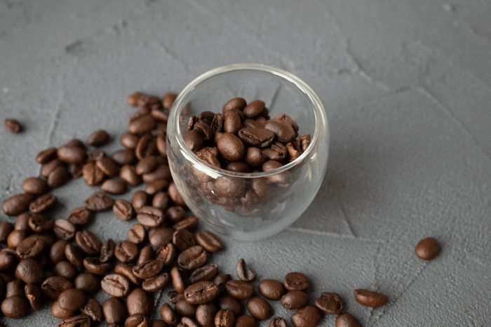 roasted coffee beans in glass cup