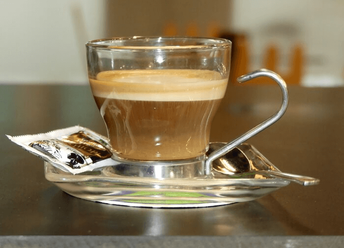 Glass cortado coffee.